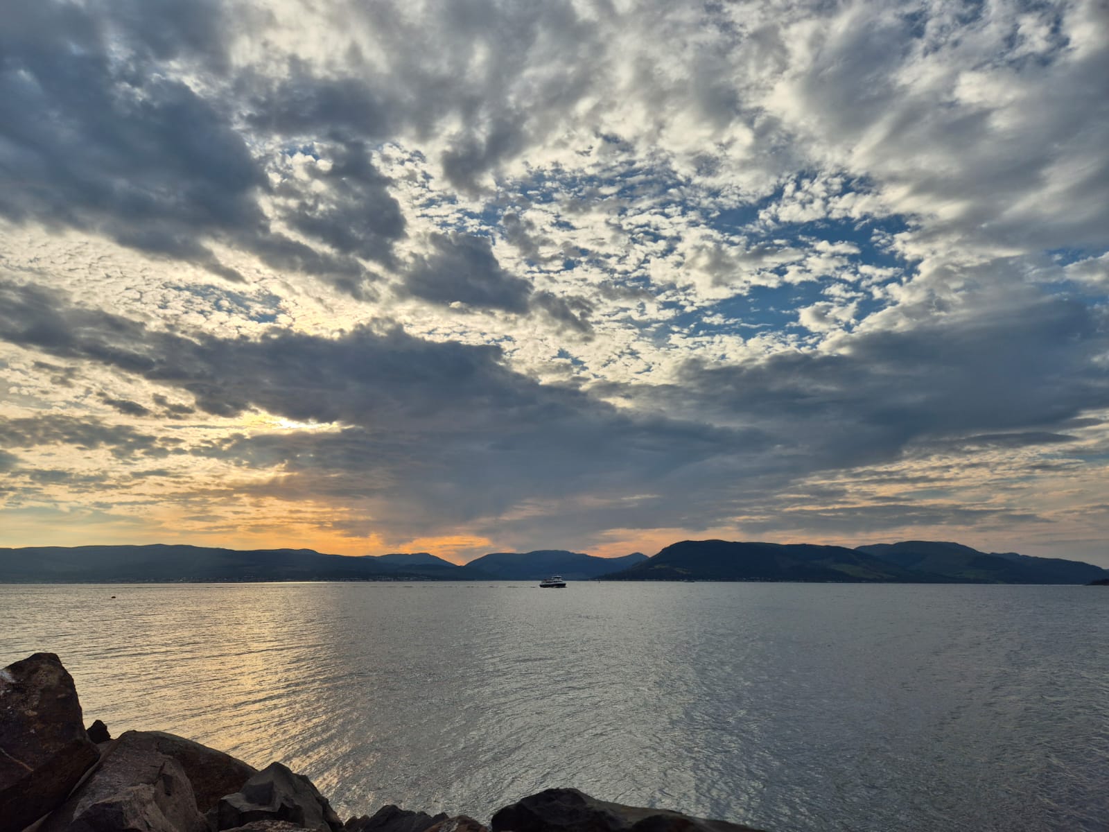 Mountain water beneath a dramatic Scottish sky