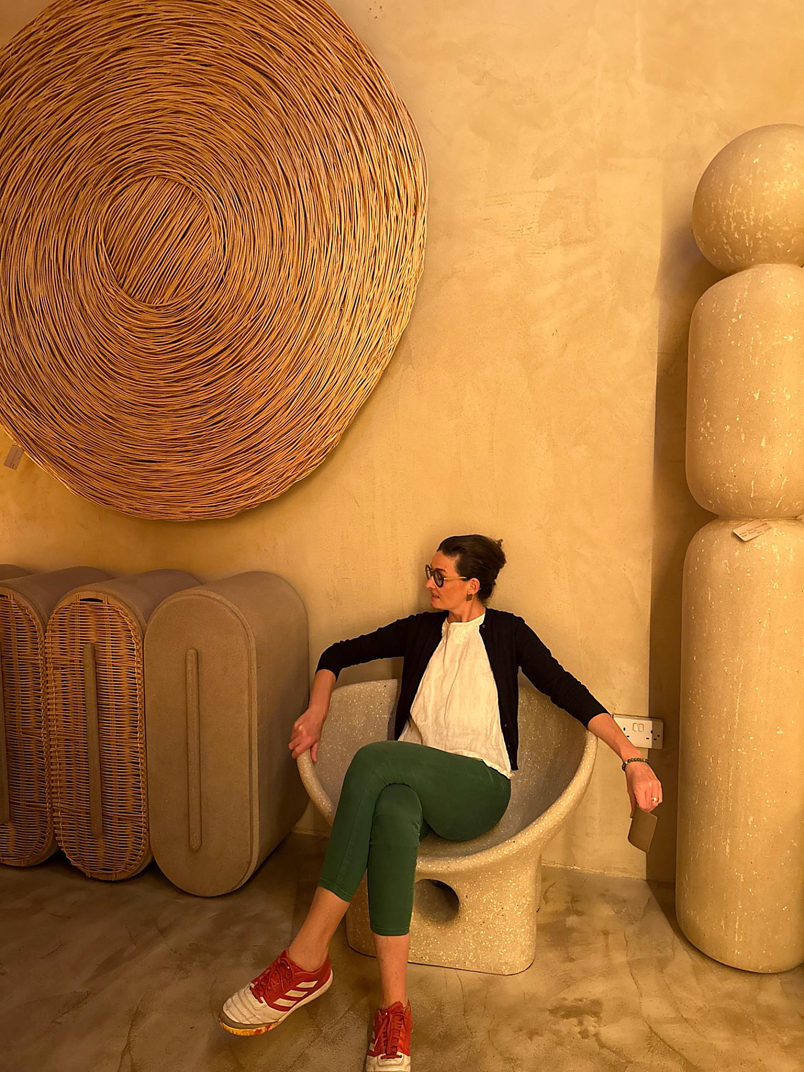 Anne Schaeflein in a room hung with woven art